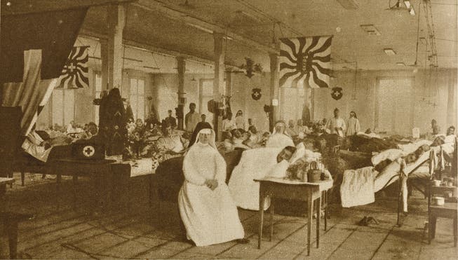 Zum Zeitpunkt der Aufnahme hatten sie noch keine Todesopfer zu verzeichnen: Im Notspital in Buchs pflegen Ordensschwestern und Sanitätspersonal grippekranke Soldaten. Bild: Staatsarchiv St. Gallen (Oktober 1918)