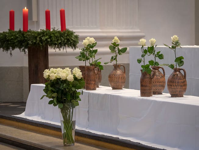 Wasserkrüge und weisse Rosen als Symbol für die sieben Opfer der Brandtragödie in Solothurn: 800 Menschen nahmen an einem Gedenkanlass in der St. Ursen-Kathedrale teil. (Bild: KEYSTONE/MARCEL BIERI)