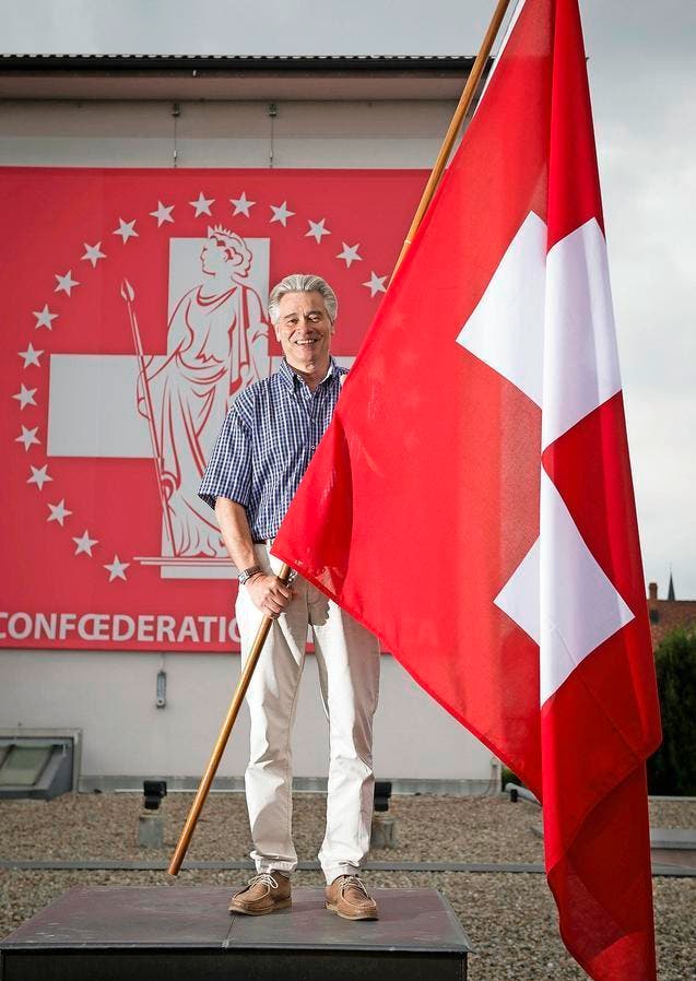 Er hat täglich mit Fahnen zu tun, aber das Schweizer Kreuz auf rotem Grund weckt bei ihm weiterhin spezielle Emotionen: Heinz Höhener auf dem Dach der Heimgartner Fahnen AG. (Bild Ralph Ribi)