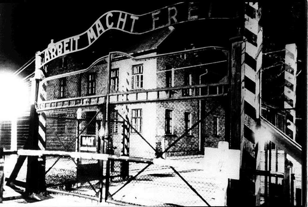 Die Toraufschrift "Arbeit macht frei" prangt über dem Eingang zum Stammlager Auschwitz I, hier in einer Aufnahme von 1945. Geschmiedet wurde der Schriftzug vom polnischen Häftling Jan Liwacz, der aus Protest gegen seine Peiniger das "B" verkehrt herum angebracht haben soll. (Bild: Keystone)