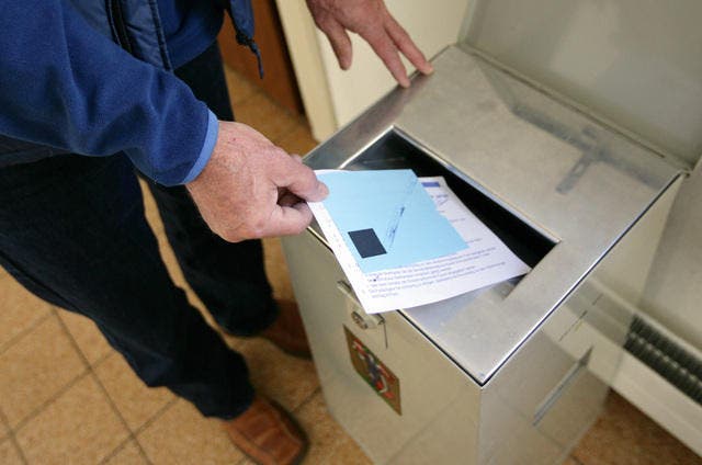 Ein Mann wirft einen Stimmzettel in eine Urne. (Symbolbild LZ)