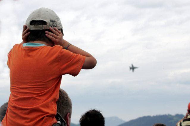 Ein Junge hält sich die Ohren zu, weil die Flugzeuge auf dem Flugplatz Emmen so laut sind. (Bild: Archiv Neue LZ)