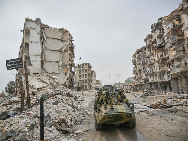 Ein Panzer in einer zerstörten Strasse in der syrischen Stadt Aleppo. Gespräche zum Syrienkrieg sollen am 23. Januar in Astana stattfinden. (Archiv) (Bild: KEYSTONE/AP RUSSIAN DEFENSE MINISTRY PRESS SERVICE)