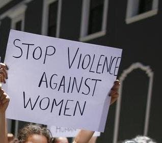 Eine Schweizerin wurde in Kapstadt ermordet. Im Bild: Eine Demonstrantin in Kapstadt hält ein Schild mit dem Satz "Stoppt die Gewalt gegen Frauen" hoch. (Bild: EPA/ Nic Bothma)