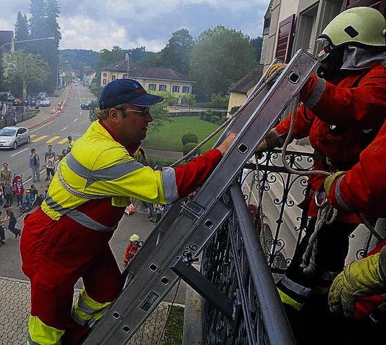 Feuerwehrmänner retten Daniel Stump über die Feuerwehrleiter. (Bild: Maya Heizmann)