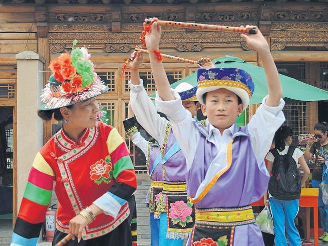 Folklore für die Touristen: Die Jugendlichen tanzen und singen. Von 9 bis 17 Uhr arbeiten sie im Pekinger Nationalitäten-Park. (Bilder: Inna Hartwich)