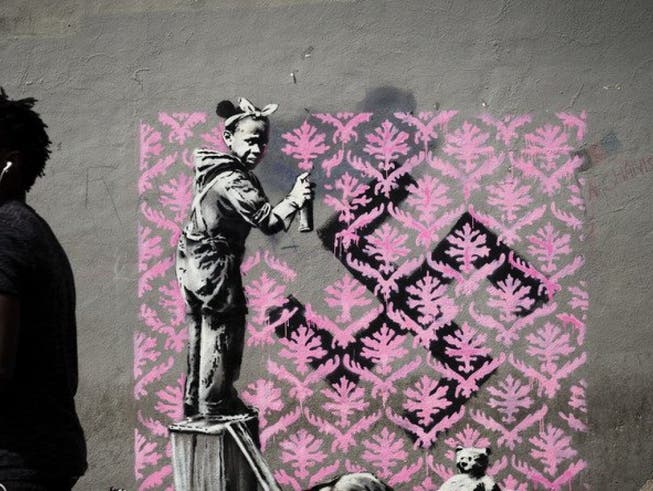 Auf Twitter wird gejubelt: Banksy ist zum ersten Mal in Paris! Bisher sind in der französischen Hauptstadt sechs mutmassliche Motive des Inkognito-Künstlers aufgetaucht. Hier ein Flüchtlingsmädchen, das ein Hakenkreuz mit einem rosa Blumenmuster übersprayt. (Twitter) (Bild: Twitter)