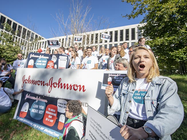 Demonstranten bei einer Kundgebung vor dem Campus Switzerland des Konzerns Johnson & Johnson J&J in Zug. Der Konzern soll laut der NGO Ärzte ohne Grenzen den Preis für das Medikament Bedaquilin auf 1 Dollar pro Patient und Tag senken. (Bild: KEYSTONE/URS FLUEELER)
