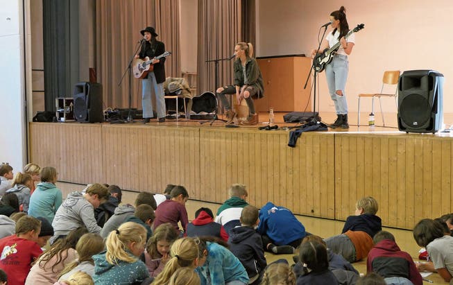 Die Band singt, die Schüler füllen derweil den Lücken-Song-Text aus. Bild: Sandra Peter (Wolfenschiessen, 12. November 2019)