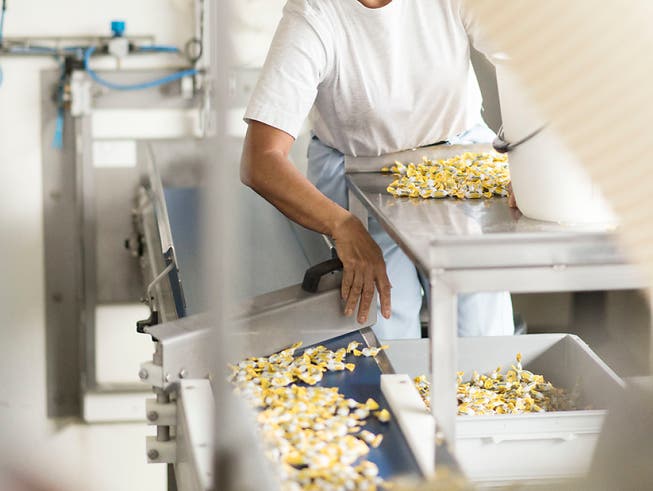 Eine Mitarbeiterin sortiert in der Ricola-Fabrik in Laufen die «Däfeli» des Baselbieter Süsswaren-Produzenten (Archivbild). (Bild: KEYSTONE/CHRISTIAN BEUTLER)