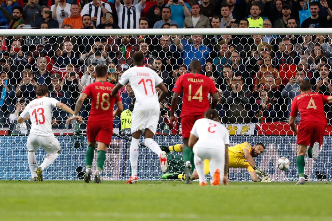 Switzerland&apos;s Ricardo Rodriguez, left, scores the opening goal from the penalty spot during the UEFA Nations League semifinal soccer match between Portugal and Switzerland at the Dragao stadium in Porto, Portugal, Wednesday, June 5, 2019. (AP Photo/Armando Franca)