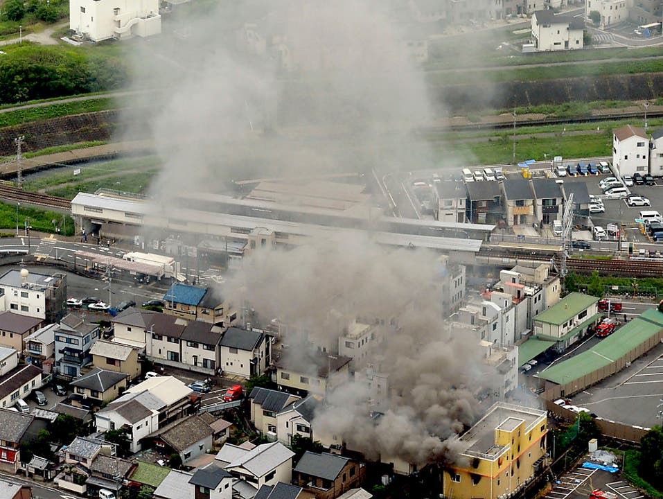 Nach dem verheerenden Brandanschlag auf ein Filmstudio in Kyoto steigt eine Rauchsäule über dem Gebäude auf. (Bild: KEYSTONE/AP Kyodo News)