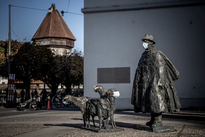 Die Bronce-Skulptur des Schäfers mit Schafen von Rolf Brem auf dem Theaterplatz trägt ebenfalls eine Schutzmaske. 