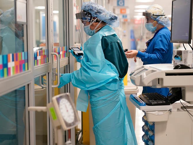 Zwei Medizinerinnen in Schutzkleidung arbeiten auf einer Station im Krankenhaus «Bellevue Hospital». Die Krankenhäuser des öffentlichen Gesundheits- und Krankenhaussystems der Stadt New York haben ihre Ausrüstung aufgerüstet, um sich auf eine mögliche zweite Welle der Corona-Pademie vorzubereiten. Foto: Seth Wenig/AP/dpa