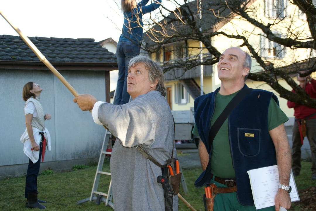 Andres Schmocker (links) und Markus Steimer geben den Kursteilnehmern gute Tipps und helfen mit der Stange, den Baum in Form zu schneiden
