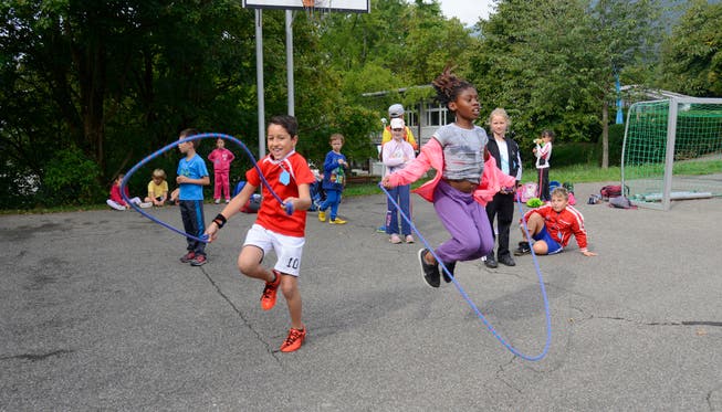 Kinder beim Seilspringen am Sporttag.