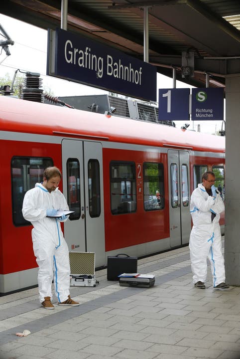 Deutsche Polizisten starten die Untersuchungen am Bahnhof Grafing in der Nähe von München.