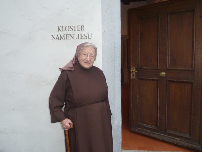Schwester Maria Anna Felder vor den Eingang zum Kloster.