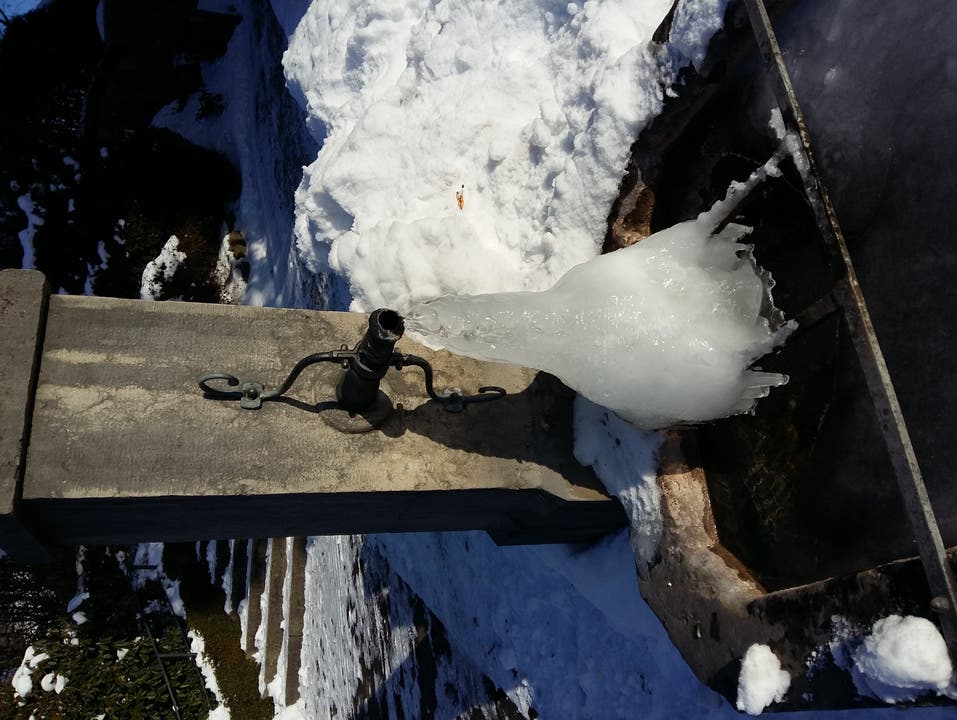 undefined Am Dorfbrunnen- Wasser plätschert durch enstandenes Eisgebilde