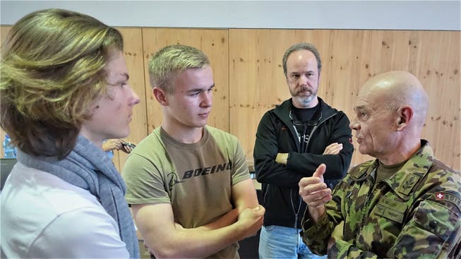 Der Chef der Schweizer Luftwaffe, Bernhard Müller (r.), unterhält sich nach seinem Auftritt an der Kanti Wettingen mit Schülern und interessierten Zuhörern. zvg