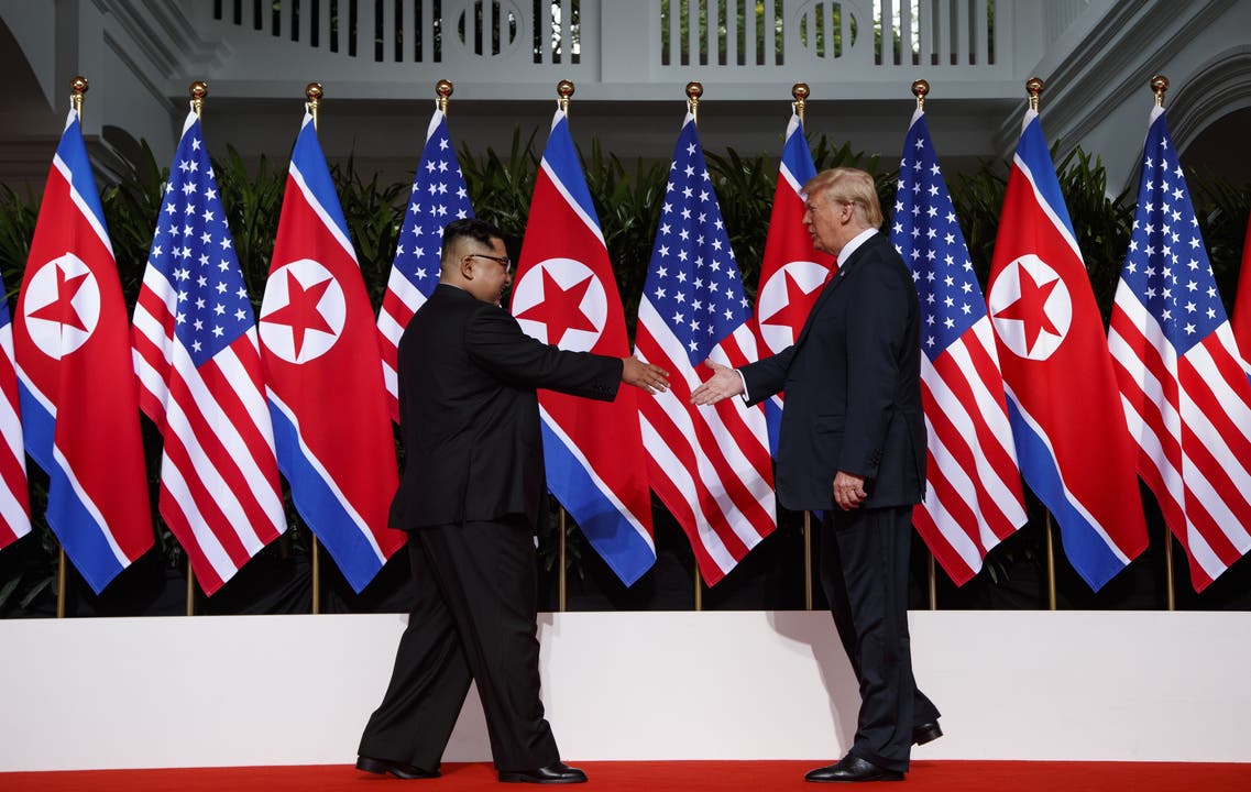 Kim scheint den Arm etwas weiter auszustrecken... President Donald Trump meets with North Korean leader Kim Jong Un on Sentosa Island, Tuesday, June 12, 2018, in Singapore. (AP Photo/Evan Vucci)