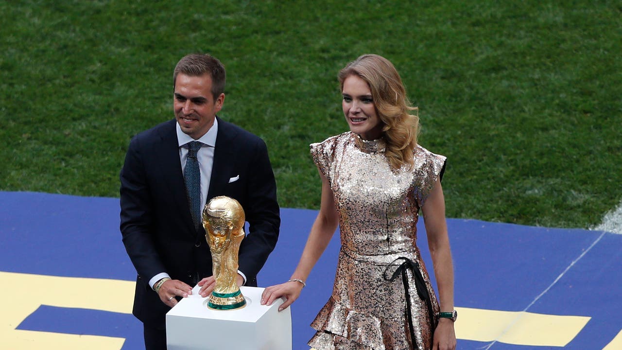 Ex-Weltmeister Philipp Lahm und Model Natalia Vodianova zeigen den WM-Pokal.