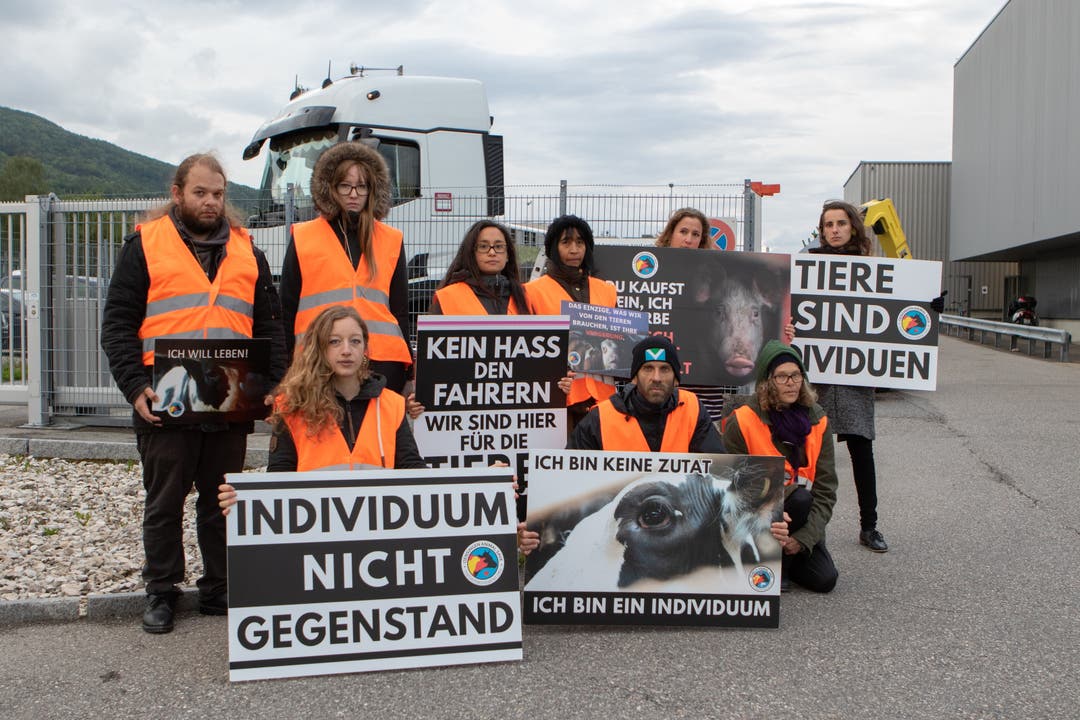 Die Tierschutzaktivisten halten bei ihrem stillen Protest vor dem Bell-Schlachthof Plakate hoch