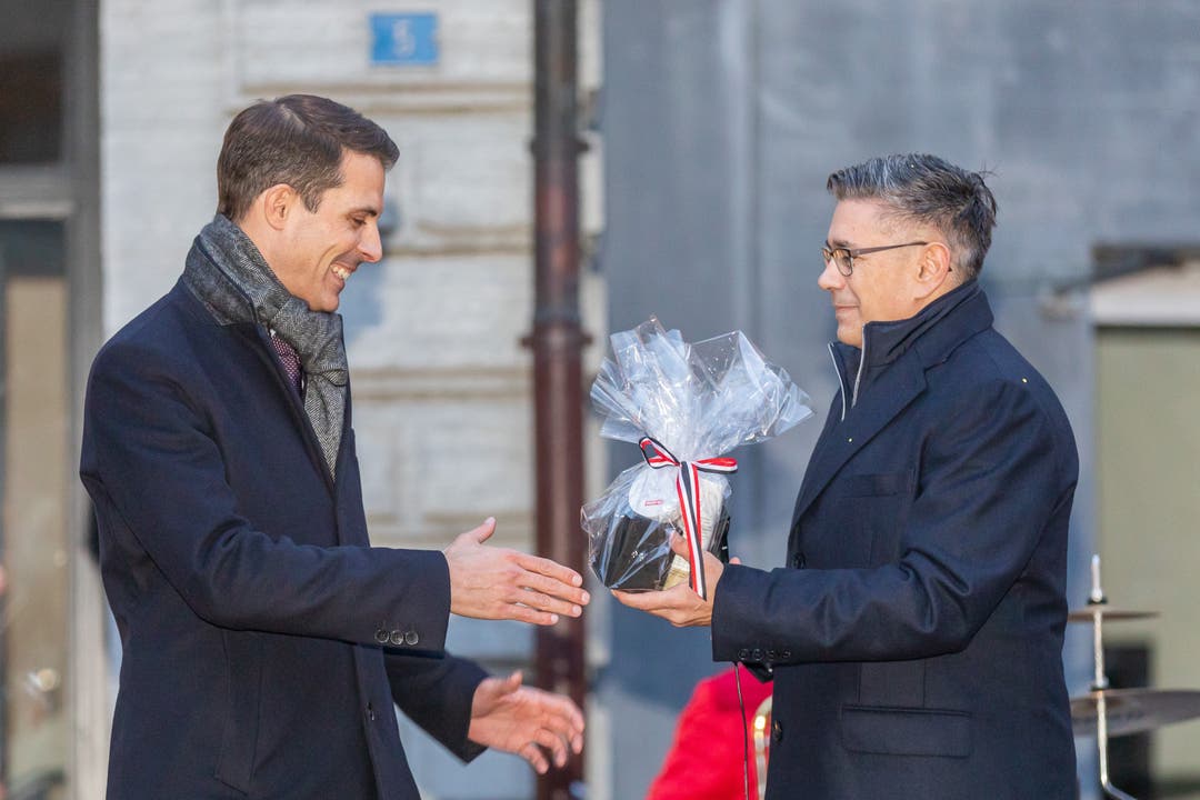 Thierry Burkart erhält ein Geschenk von Badens Stadtammann Markus Schneider.