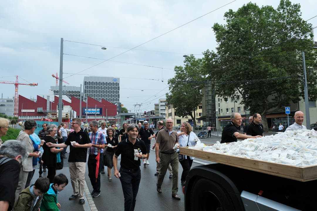 Dahinter verteilen Mitglieder des Fest-OKs und Schlieremer Stadträte Taschentücher für Freudentränen und Gummibärchen.