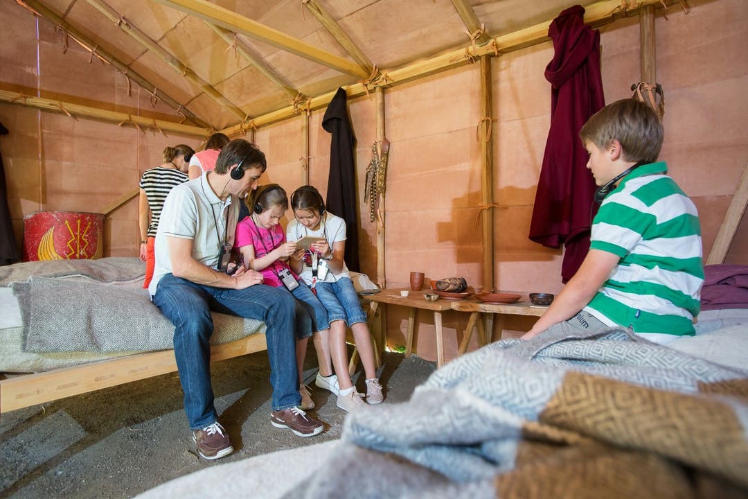 Eine Familie hört auf dem Krankenlager im Lazarett von den Geschichten der Patienten