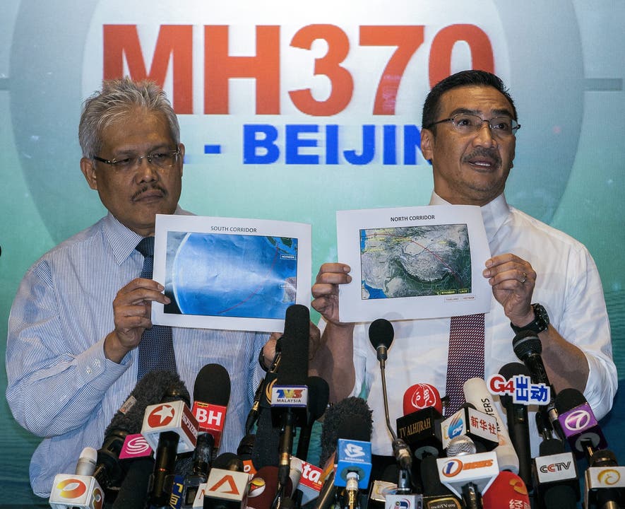 Der malaysische Verteidigungsminister Hishamuddin Hussin (rechts) und der Minister für auswärtige Angelegenheiten Hamzah Zainudin zeigen Bilder der Flugrouten, welche MH370 genommen haben könnte.