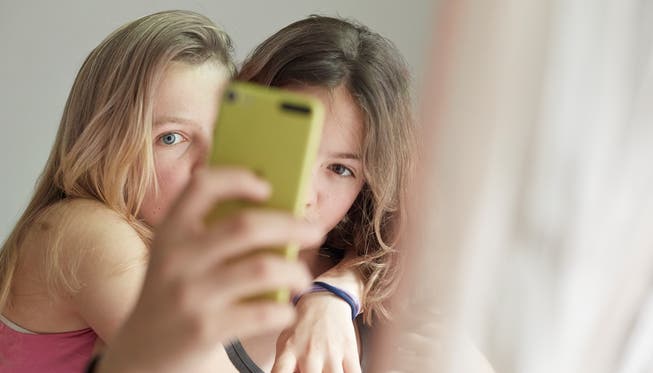 Die beiden Mädchen suchen gerade nach dem idealen Aufnahmewinkel für ein Selfie. Smartphones können manchmal ganz schön stressen. Leo Thal/ KEYSTONE