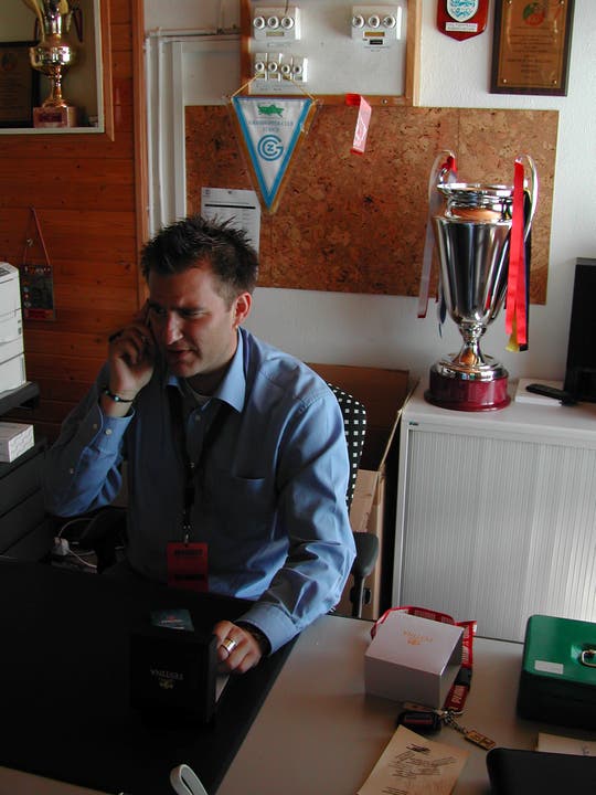 Sascha Ruefer am Telefon, neben ihm der Uhrencup-Pokal (2004)
