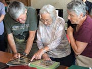 Gäste blättern in den original Dokumenten, die Dorfchronist Werner Schwendimann seinerzeit zusammengetragen hat. (Bild: Evi Biedermann)
