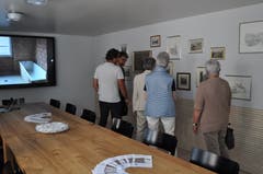 Das neue Sitzungszimmer des Gemeinderates mit grossem Bildschirm und Bildern.