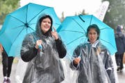 Agi und ihre Kollegin behelfen sich mit Regenschirm und Pelerine. (Bild: Mario Testa)
