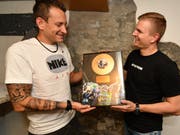 Reto Sturzenegger, Obergugger der Marktplatzpfuuser, bekommt von Präsident Samuel Svec eine Urkunde in Form einer goldenen Schallplatte, die ihn als Ehrenmitglied der Pfuuser auszeichnet. (Bild: Manuel Nagel)