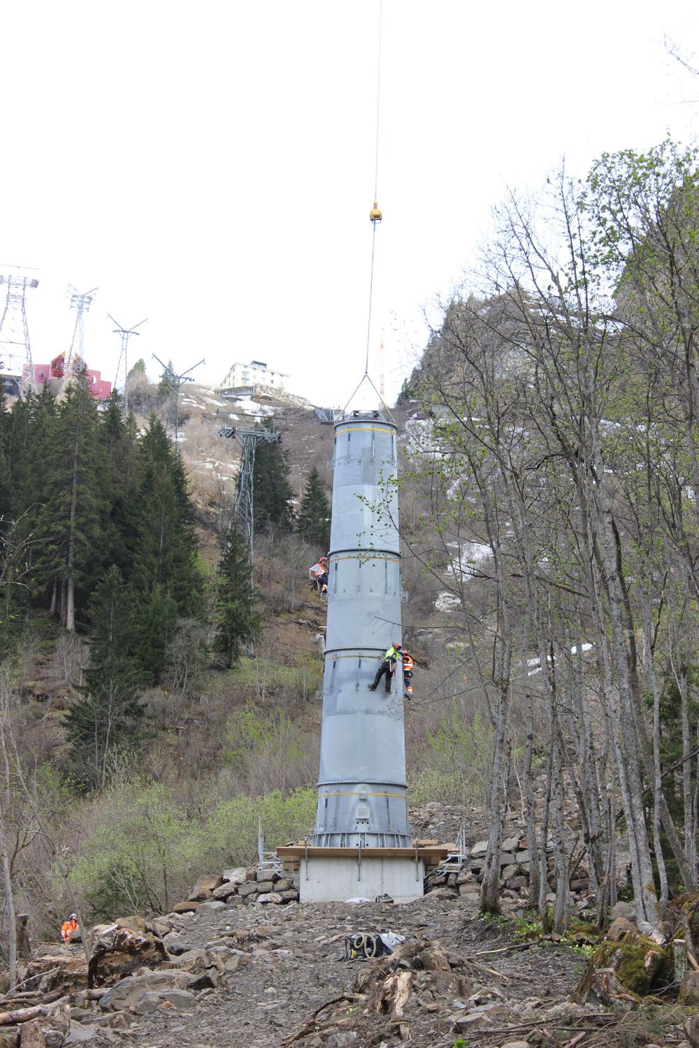 11.05.2015: Die Montage des höchsten Masten beginnt (hinten: die alte Seilbahn, links die Luftseilbahn). (Bild: Mike Bacher)