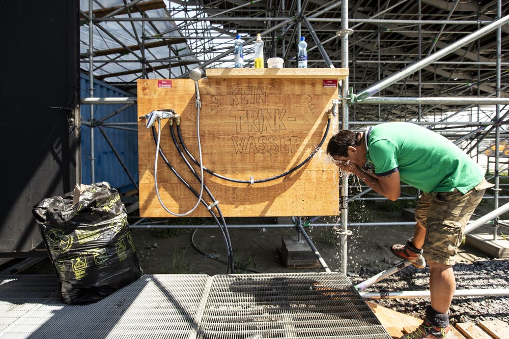 Wasser sorgt für Abkühlung bei den Arbeitern. (Bild: Alexandra Wey / Keystone, 24. Juli 2019)