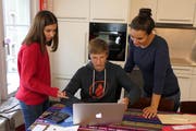 Karen (13) rechnet mit Laurence (15) vom Büroteam ab. Conny Egger von der Jugendanimation Zug (Jaz) unterstützt, wo nötig.
