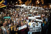 Separatisten-Anhänger demonstrieren für die Freilassung der inhaftierten Politiker, darunter Jordi Sànchez und Jordi Cuixart, die auf dem Poster abgebildet sind. (Bild: Emilio Morenatti/AP (Barcelona, 16. Oktober 2018))
