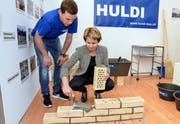 Polier Dominik Ziltener zeigt Ständerätin Brigitte Häberli an der Bichelseer Gewerbemesse «Schaufenster» das Maurerhandwerk. Der Anlass wurde bis anhin von der Gemeinde organisiert, künftig soll der Gewerbeverein ans Ruder. (Bilder: Christoph Heer, 6. April 2018)
