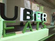 Uber will seinen Dienst für Essenslieferungen in der Romandie lancieren. In den USA deckt Uber Eats bereits rund die Hälfte der Bevölkerung ab. (Bild: Keystone/AP/LEE JIN-MAN)