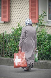 Ob das Kopftuch an Schweizer Schulen erlaubt sein soll, ist eine der Fragen, die die Parteien umtreibt. Im Bild eine Muslima in einem St. Galler Wohnquartier. (Bild: Ralph Ribi (3. September 2014))