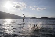 Zwei Jungs aus Stans schweben bei tollstem Sommerwetter auf Seilen über den Vierwaldstättersee. (Bild: Urs Flüeler / Keystone (Kehrsiten, 17. Juni 2017))
