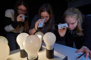 Die eingeladenen Schülerinnen aus Reiden erforschen verschiedene Lichtquellen mittels Spektroskop. (Bild: PH Luzern)