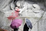 Touristen betrachten den verunglimpften Löwen. (Bild Pius Amrein/Neue LZ)