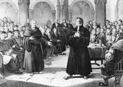 Der Schweizer Reformator Ulrich Zwingli im Disput mit einem Mönch im Jahr 1523 in Zürich. (Bild: Getty)
