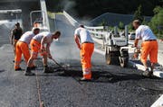 Arbeiter verlegen den Strassenbelag, hier beim Tunnel in Lungern. (Bild: Archiv / Neue LZ)