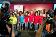 Schulkinder nehmen an der Verleihung des 1. Schulpreises die Bühne im Berner Stade de Suisse in Beschlag. Hinten links stehen die Moderatoren und Preisverleiher Fabian Cancellara und Christa Rigozzi. (Bild: Keystone/Peter Schneider)